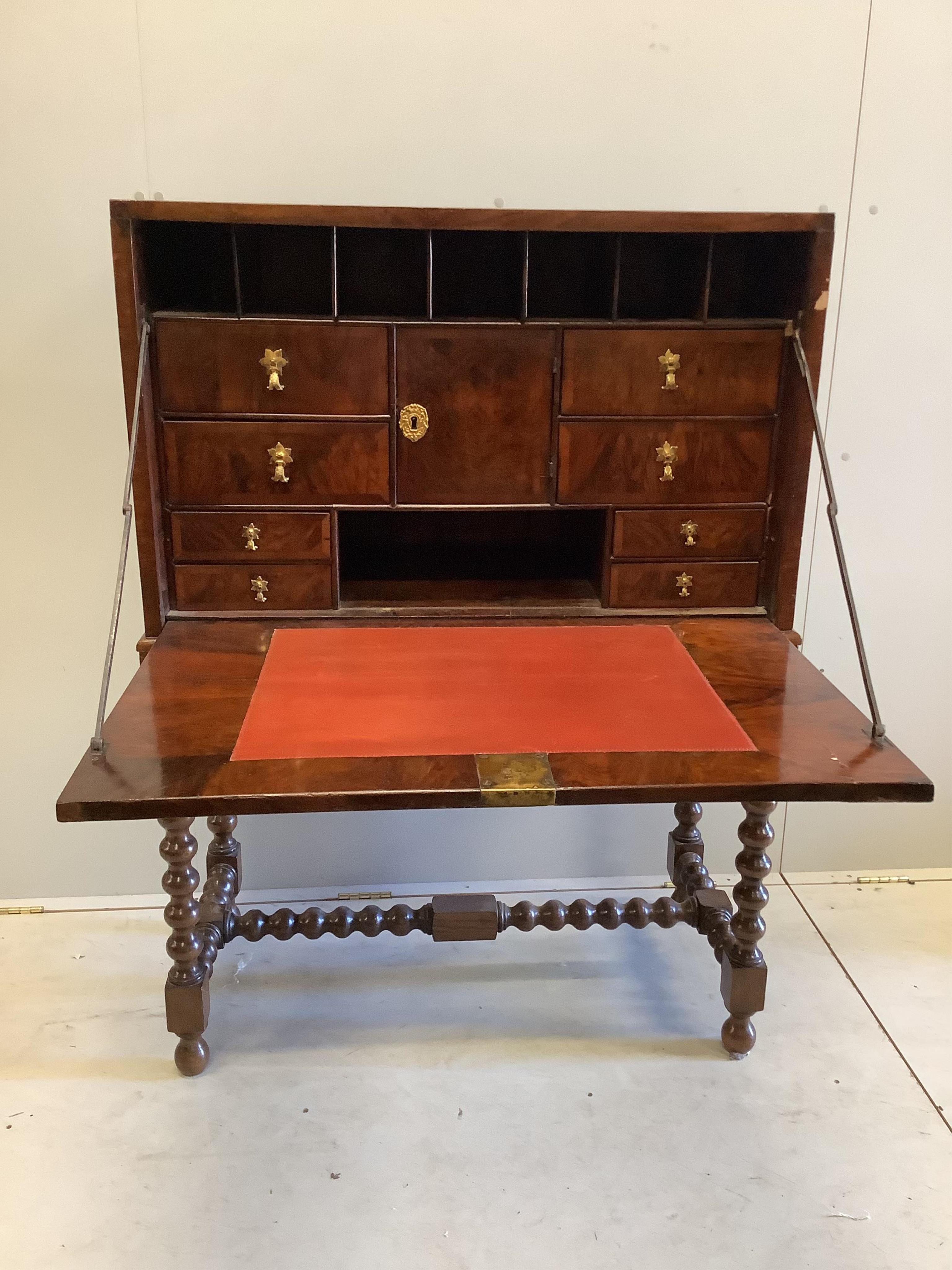 An 18th century walnut secretaire cabinet on later stand, width 91cm, depth 44cm, height 130cm. Condition - fair